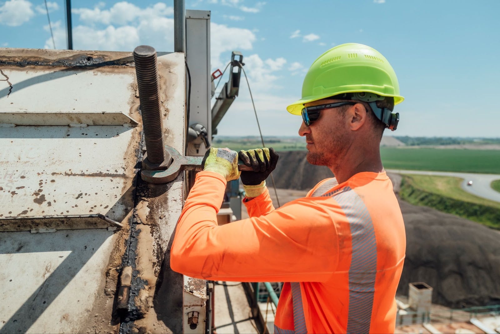 Worker wearing a cooling orange hi vis sun shirt